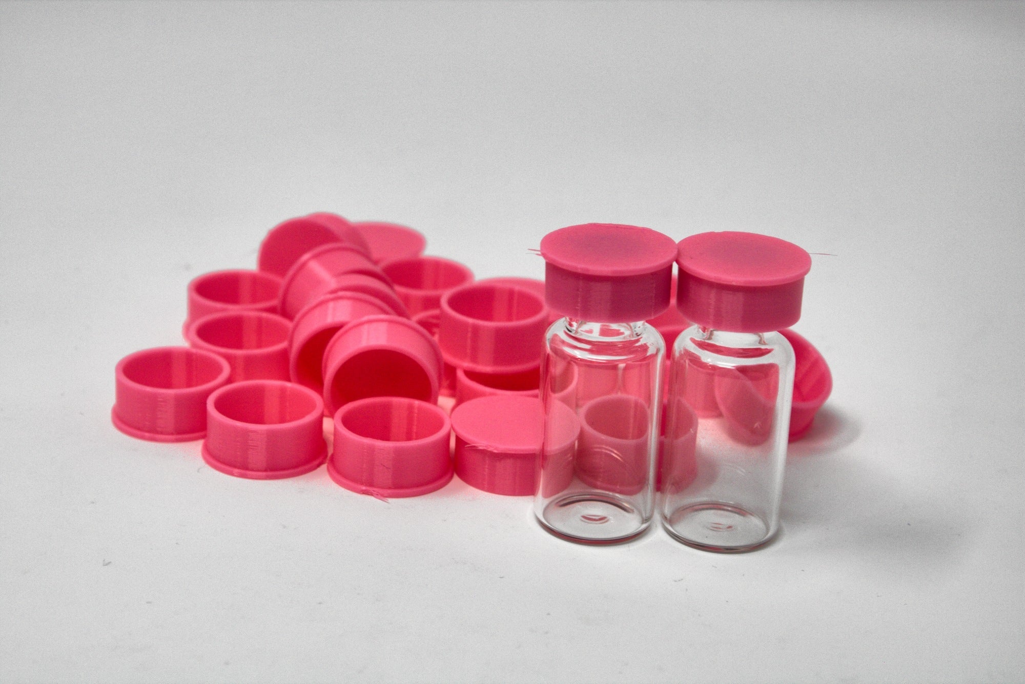 Pink reusable TPU vial caps with vials