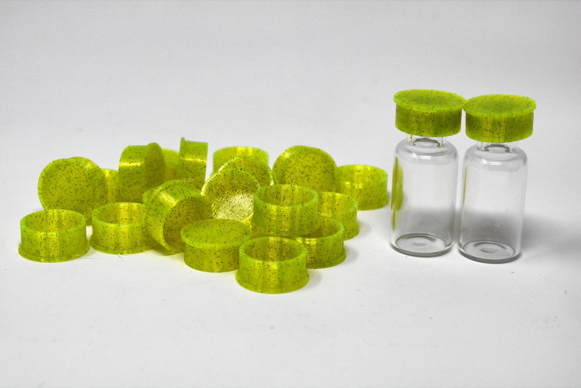 Lime green reusable TPU vial caps with vials