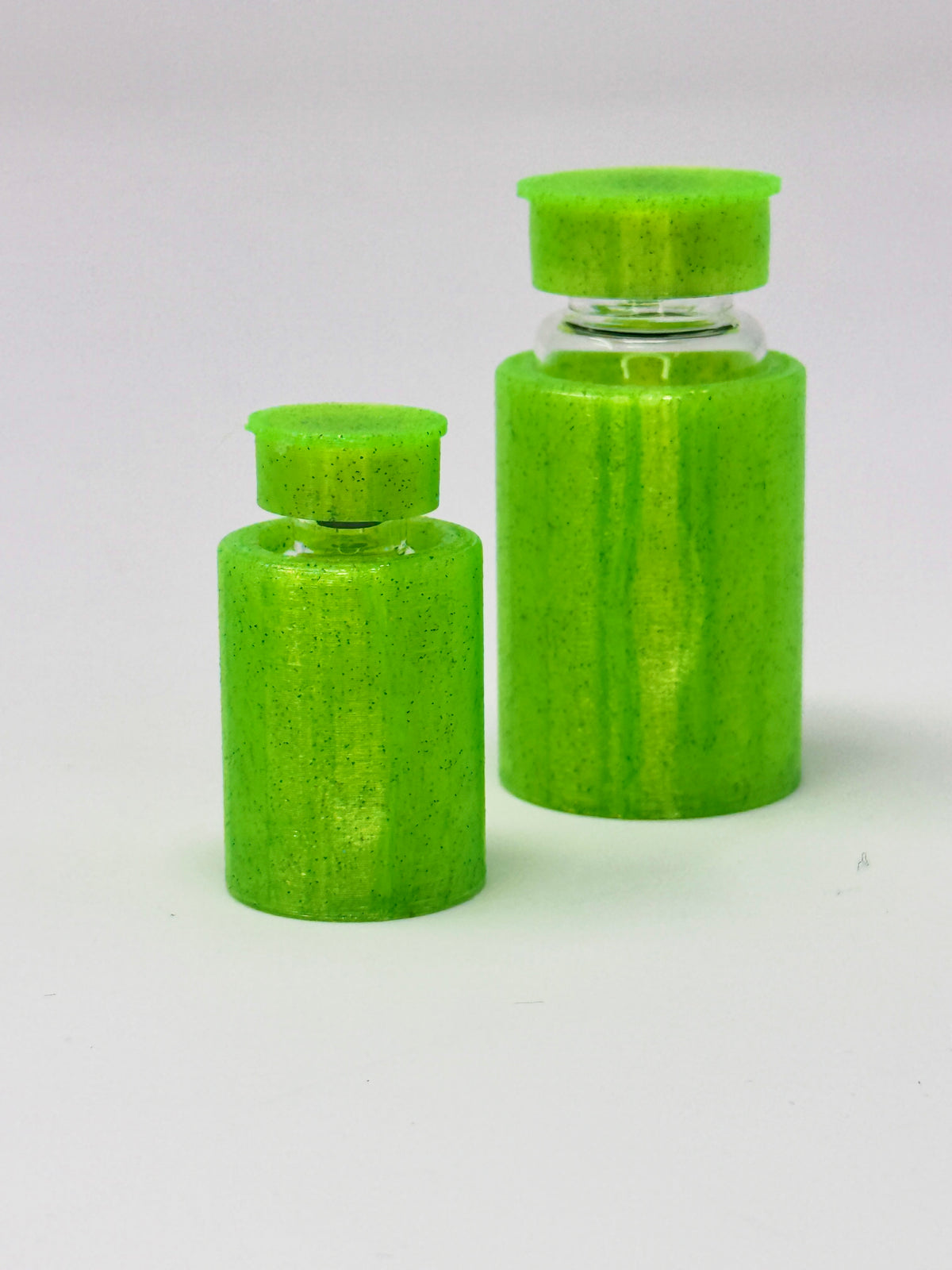 VialLock Green vial sleeves shown on 3 mL and 10 mL demonstration vials. Each order contains three sleeves of one selected size; matching caps included only with the cap option.