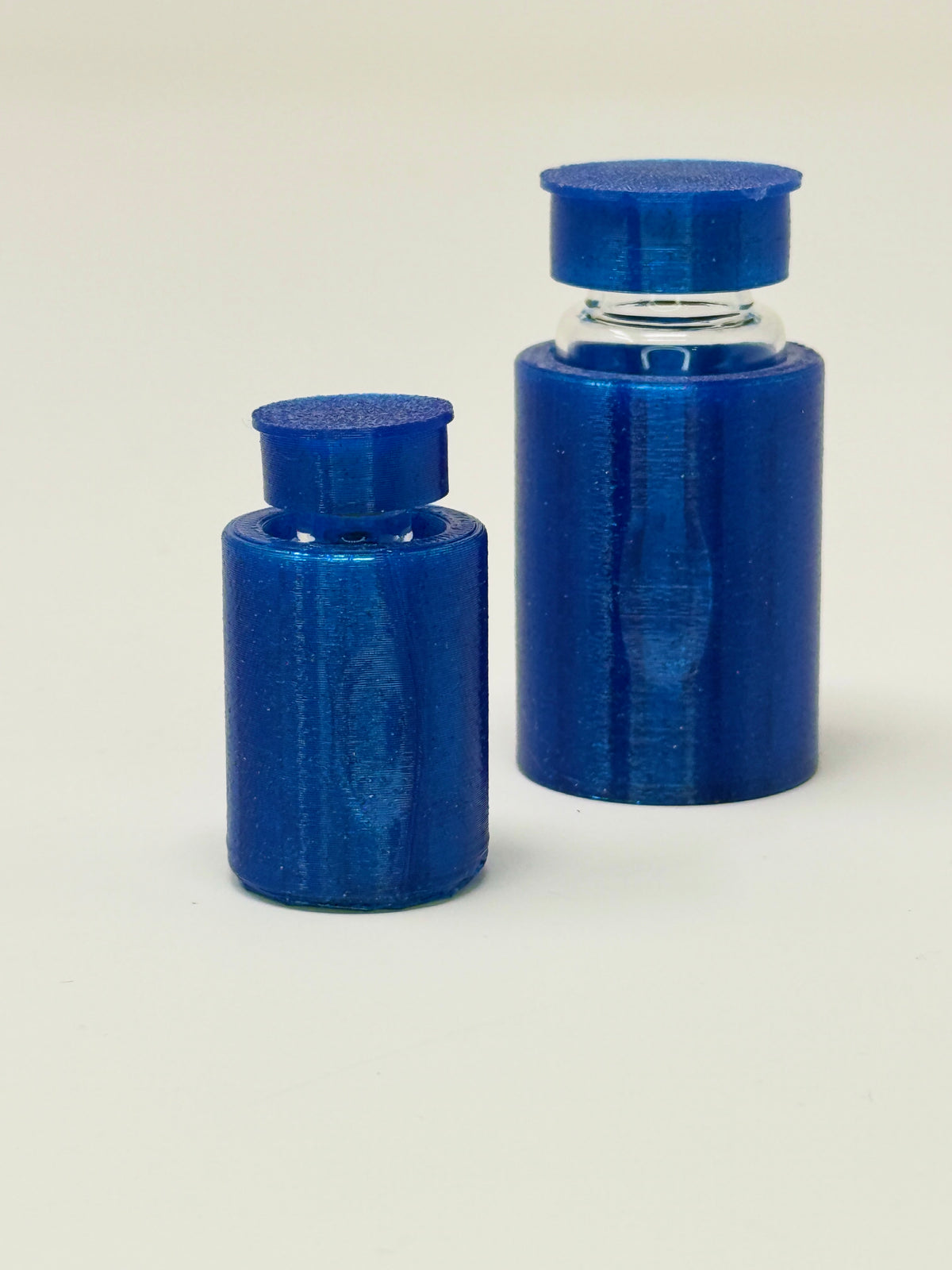 VialLock Blue vial sleeves shown on 3 mL and 10 mL demonstration vials. Each order contains three sleeves of one selected size; matching caps included only with the cap option.