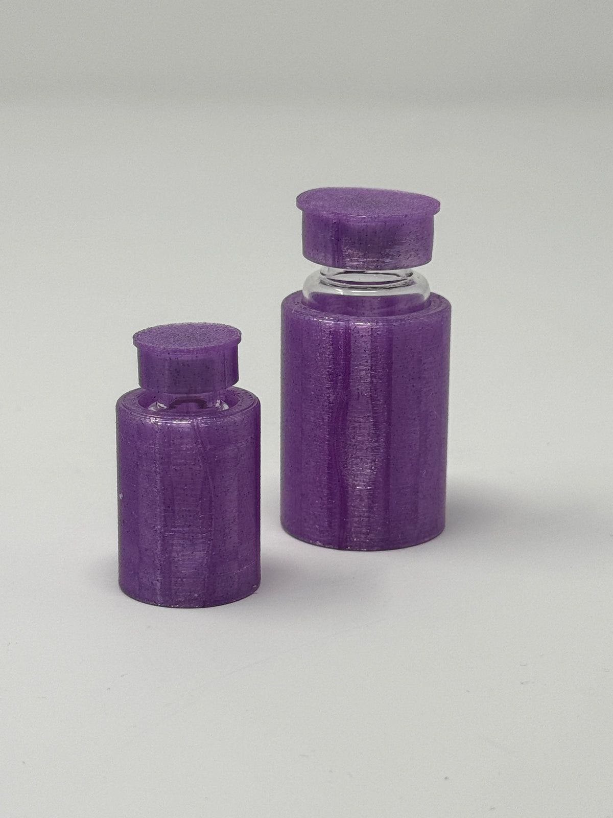 VialLock Purple vial sleeves shown on 3 mL and 10 mL demonstration vials. Each order contains three sleeves of one selected size; matching caps included only with the cap option.